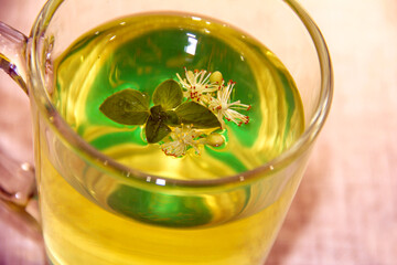 Lime tea with mint leaves and lime flowers.