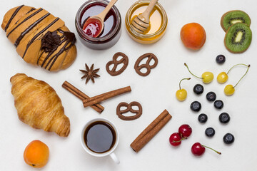 Croissants and figured cookies, berries, apricots honey, jam, cinnamon.