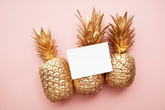 Gold pineapple minimal flat lay with a blank white card