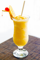 A glass of healthy banana juice drink with pulp decorated with a slice of banana. Close up. Healthy diet food.