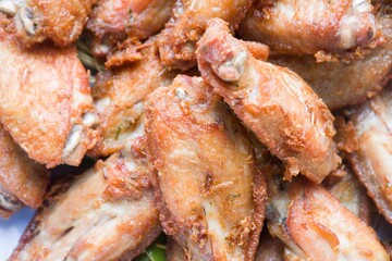 Deep fried chicken leg in colorful lemongrass.