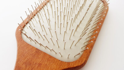 Wooden massage hair brush with iron bristles, macro side view