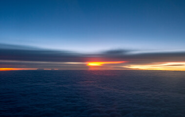 Blue clouds at sunset from an airplane