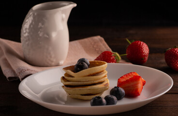 pancakes served with strawberries and blueberries