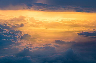 Blue clouds at gold sunset from an airplane