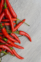 red chili or chilli cayenne pepper on white wooden table