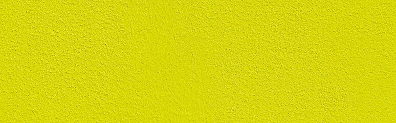 Uneven yellow decorative exterior plaster in saturated color