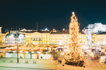 Helsinki, Finland. Christmas Xmas Market With Christmas Tree On Senate Square In Evening Night...