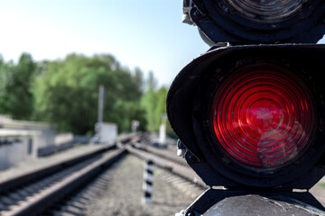 A red semaphore and empty railway tracks. Close-up