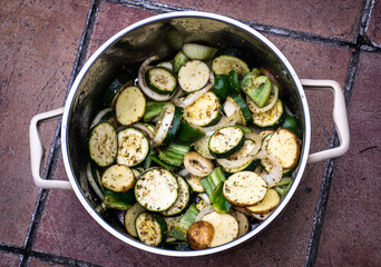 Pot with mix of vegetables inside.
