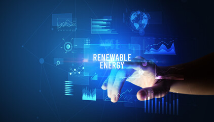 Hand touching RENEWABLE ENERGY inscription, new business technology concept