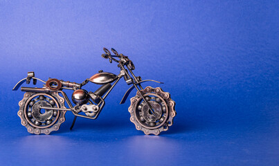 Homemade metal model - toy sports road bike stands on a blue background