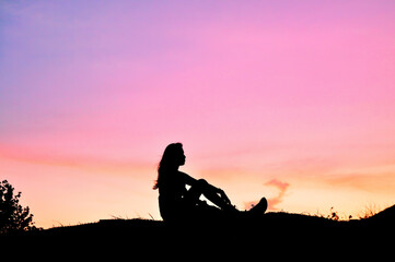 Teen Silhouette and the Seaside Light as the Sun sets
