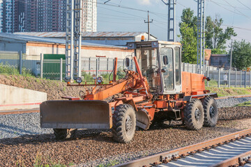 Grader stands by the railway construction site.