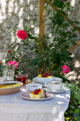 Breakfast in the garden from casseroles, berries, sauces and drinks. Rustic style.