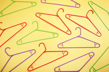 Clothes hangers on yellow background ,top view.