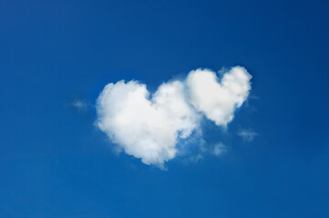 Naklejka na ściany i meble twin clouds shaped heart on bright blue sky