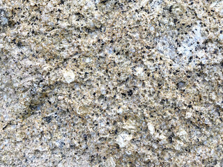 Close-up shot of a large rock with a white and gold dividing beside the sea that has been eroded by the sea until it is beautiful for artwork or graphic design. wallpaper, background, or backdrop.