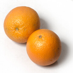 Two Oranges on isolated white background. close up. top angle. 