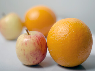 Two Apples and Oranges on isolated white background. with the depth of field. 