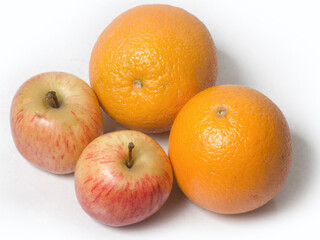 Two Apples and Oranges on isolated white background. close up. top angle.