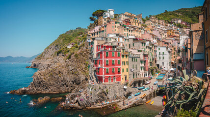 Fototapeta na wymiar Italian landmark village Riomaggiore, view of the colorful houses along the coastline of Cinque Terre area in Italy.