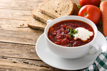 Traditional Ukrainian Russian borsch. Beetroot soup on wooden table. Copy space	