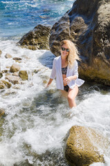 Attractive young woman in swimsuit by the sea