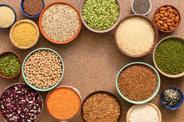 Frame of various legumes, grains, seeds in bowls. Top view, flat lay, space for your text.