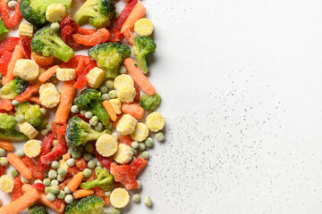 Border of frozen food vegetables on white background. Space for text.