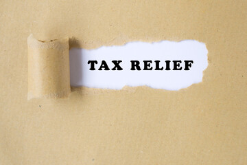 Tax Relief text on torn paper