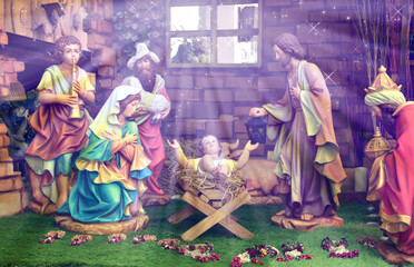 Statuettes of Mary, Joseph and baby Jesus,The birthday of Jesus is a statuette of Maria with Joseph and newborn Jesus on the hay, A Christmas nativity scene.