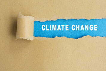 Climate change words on torn paper background.