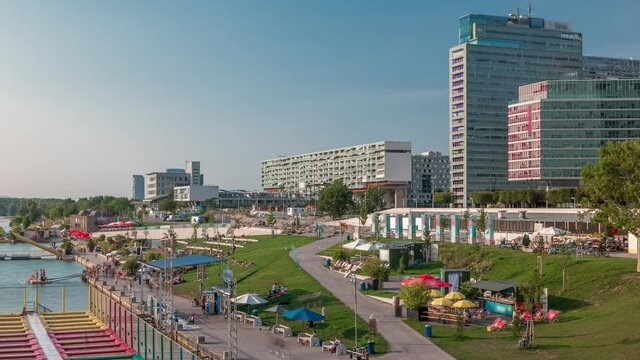 View of Copa Cagrana timelapse (or Copa Beach), an area by the Neue Donau (New Danube) in the 22th district of Vienna, with bars, restaurants and free-time activities. Green lawn and skyscrapers