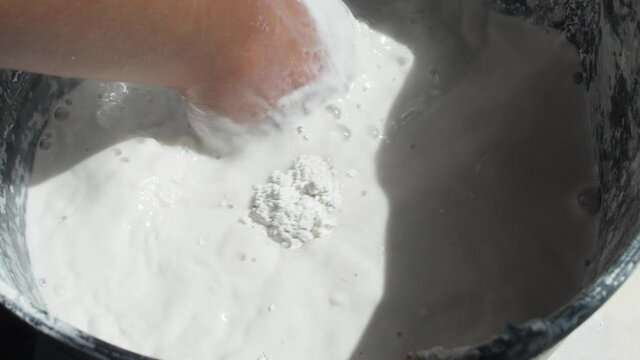 mixing plaster in a bucket by hand slow motion