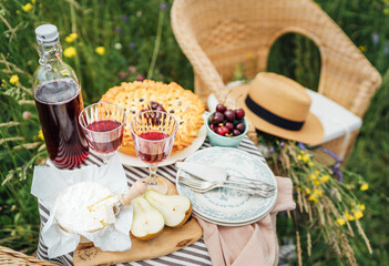 Served Table top view with beautiful vintage wine glasses, silver cutlery, plates and tableware, tablecloth, sweet cherry pie and fresh cherries still life. Homemade baking and recipes illustration.
