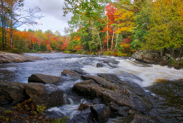 The river rapid in a public park with autumn leaf color.