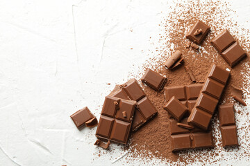 Tasty chocolate and powder on white background. Sweet food