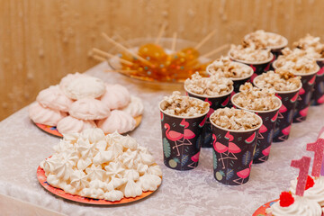 Fototapeta na wymiar Candy bar for a children's birthday party for a girl
