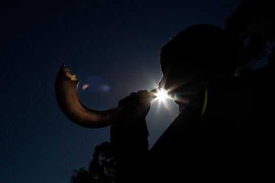
Man blowing Shofar, horn used as a musical instrument by Jews