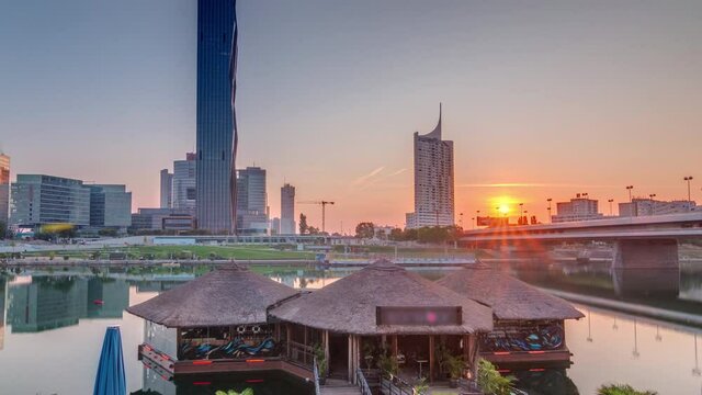 Sunrise over Donaustadt Danube City timelapse is a modern quarter with skyscrapers and business centres in Vienna, Austria. Modern architecture with reflections at morning