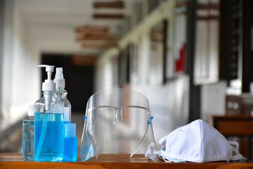 New normal, Hand sanitizer gel, faceshield and facemasks in front of the office for cleaning hands and wearing on face before getting inside to protect and prevent Coronavirus or Covid-19 and germs.