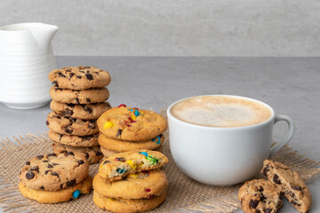 Cup of coffee and cookies on a gray background