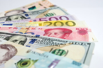 different world banknotes on a white background. Dollars, euros, yuan, hryvnia. Close-up plan. Financial concept.