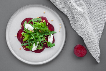 Vegetable salad of fresh beets, arugula, cottage cheese, pine nuts