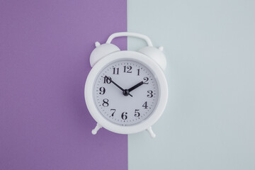 Alarm clock on colorful background. Top view.