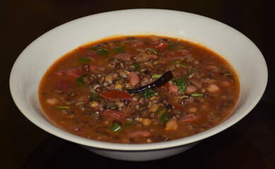 Indian Punjabi Dish Dal Tadka (Lentils) served on a white plate. Side Angle shot