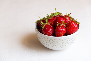 strawberries in a bowl on a white background