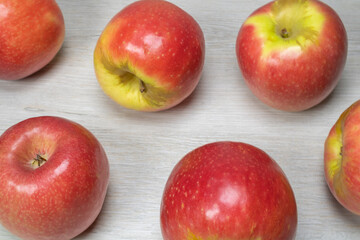 Background on the theme of fruits, apples. Apples on a background of bleached wood.
