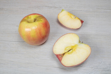 Naklejka na ściany i meble Background on the theme of fruits, apples. Apples on a background of bleached wood.
